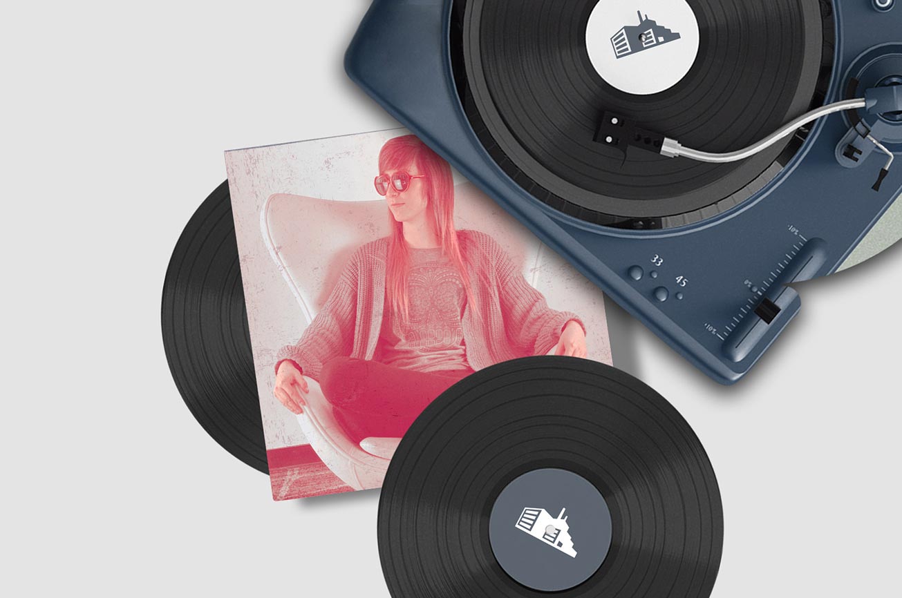 Record player with vinyl records and an album cover featuring Erika
